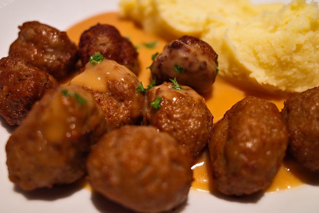 Traditional Czech svíčková dish with cream sauce and bread dumplings on a wooden table